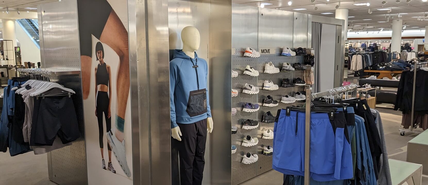 ON Running display inside Nordstrom Store that showcases men's shoes and apparel and women's apparel and installed by Nationwide Fixture Installations NFI.