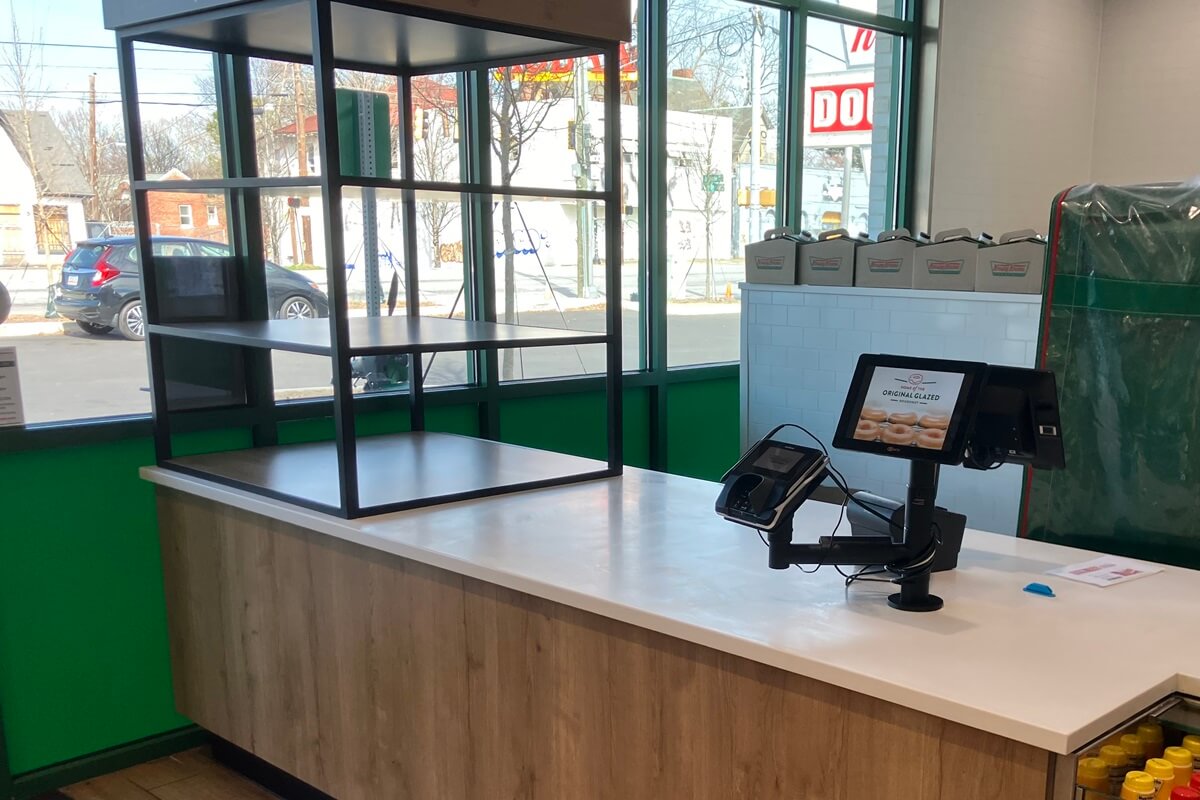 Check out counter with to go shelf inside Krispy Kreme located in Atlanta, Georgia. Installation work done by Nationwide Fixture Installations.