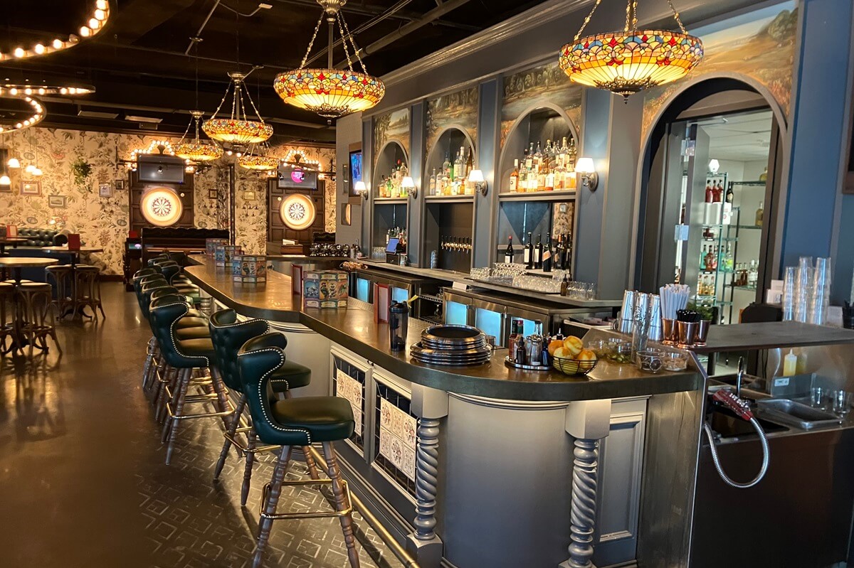 Inside bar area of Flight Club in Atlanta, Georgia with dart board areas near bar. Installation completed by Nationwide Fixture Installations.