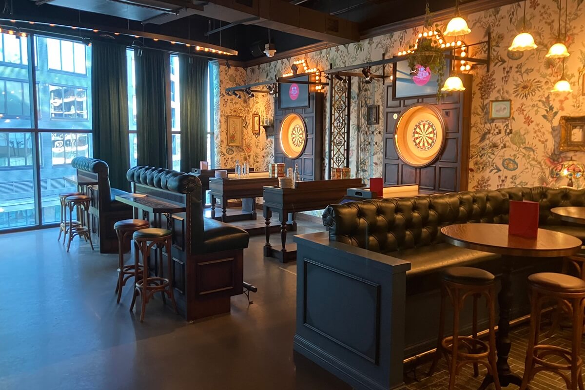 Inside of Flight Club in Atlanta, Georgia showcasing dart board area with booths and sitting option. Installation completed by Nationwide Fixture Installation.